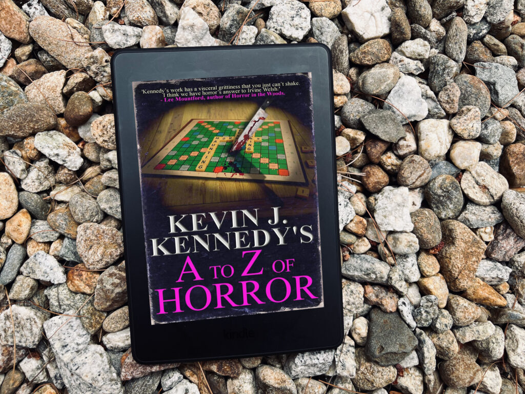 Book photo of A to Z of Horror by Kevin J. Kennedy, featuring a scrabble game sitting on a table with a bloody knife through it