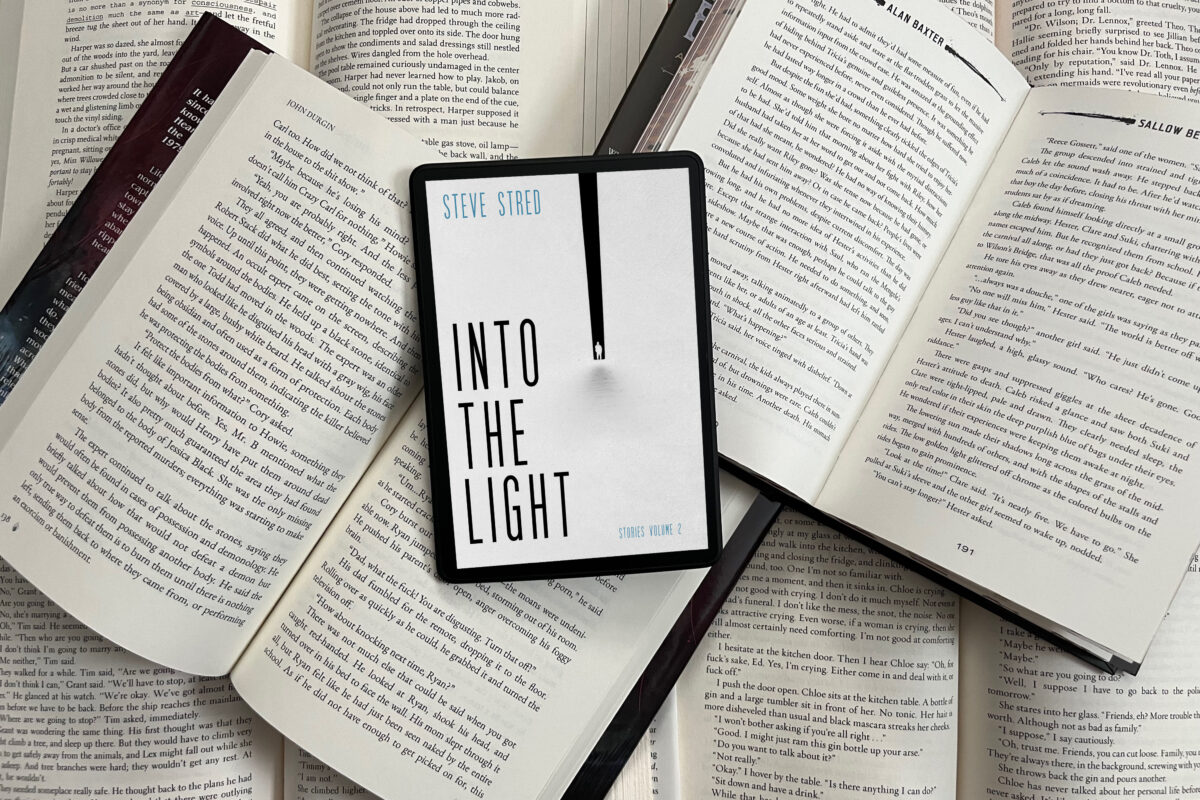 Into the Light: Stories Volume 2 by Steve Stred photo and book review by Erica Robyn Reads - image features a pile of open books with kindle on top