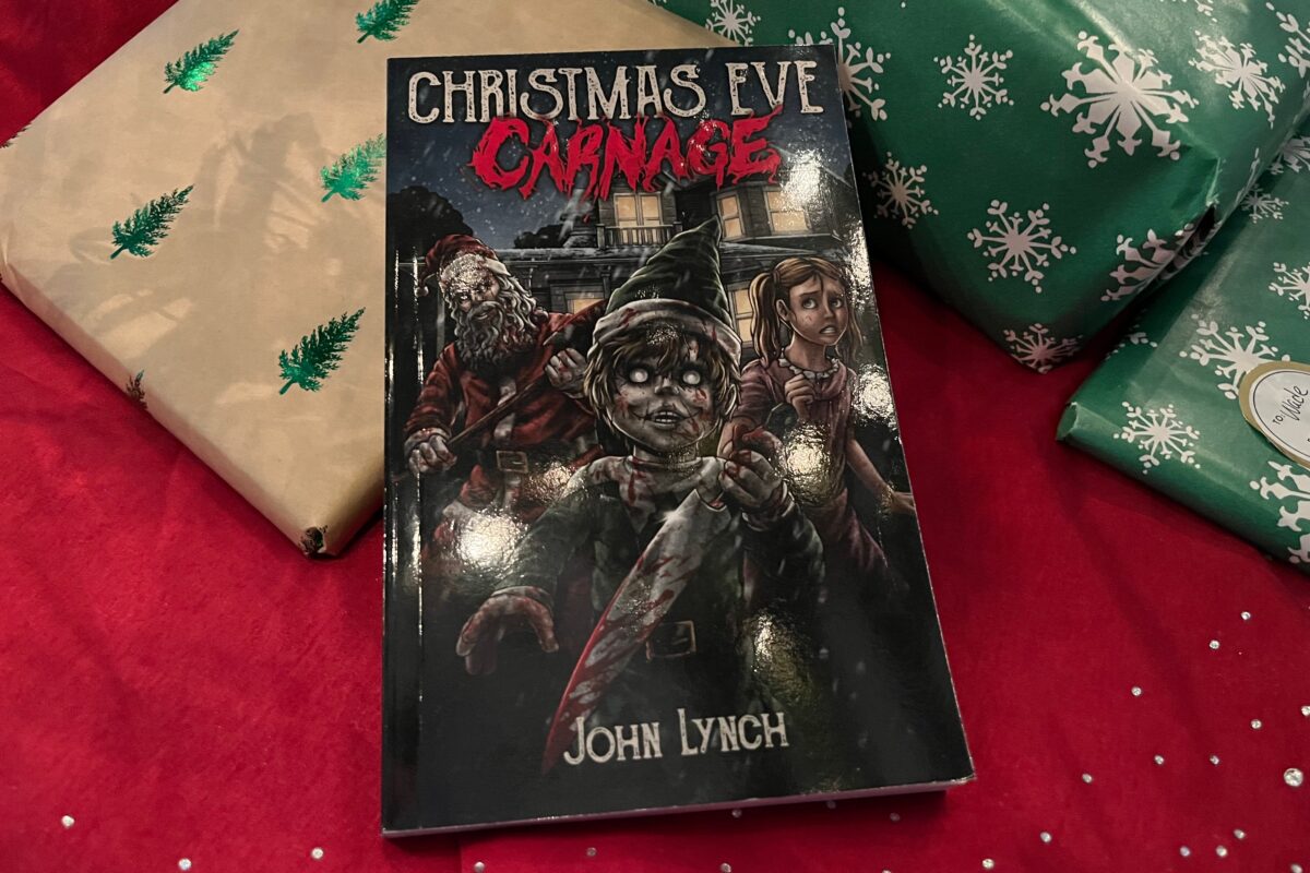 Book photo of Christmas Eve Carnage by John Lynch - a horror book cover featuring a terrifying Santa, Elf with a knife, and a little girl