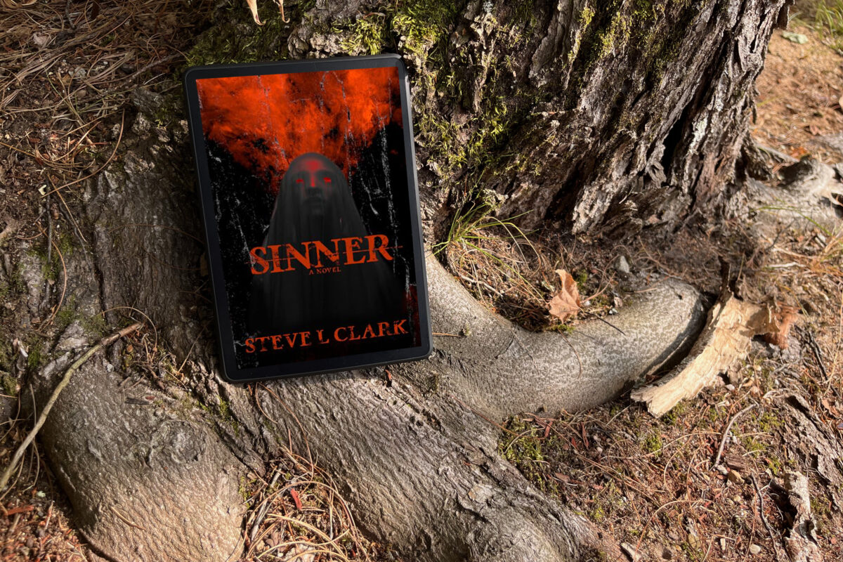 Sinner by Steve L. Clark - Book cover featuring a woman with red eyes and a black veil