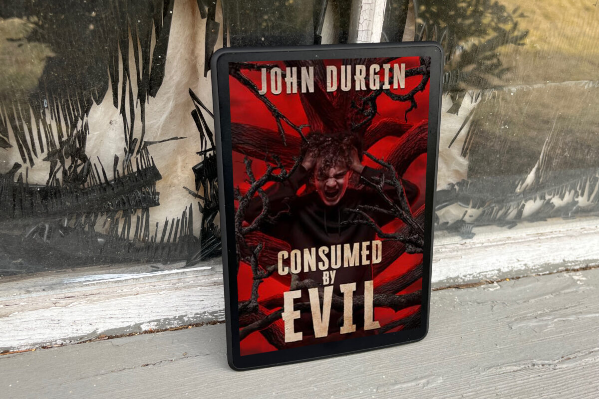 Consumed by Evil by John Durgin - Dark red book cover featuring a boy in pain with lots of black branches reaching toward him